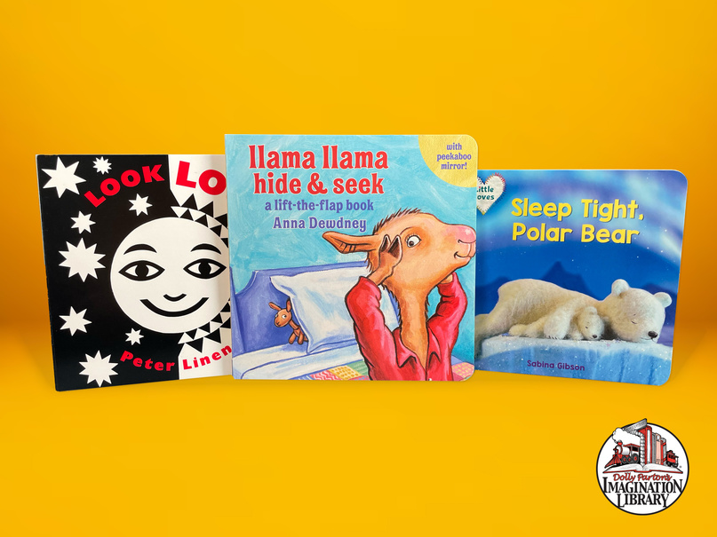 Three childrens books on a yellow background, including Llama Llama Hide & Seek.